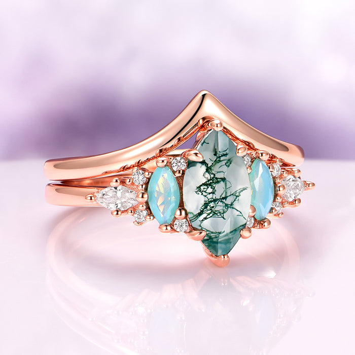 Emerie Moss Agate & Opalescent Sapphire Engagement Ring Set in 14K Solid Rose Gold featuring a marquise moss agate center stone with opalescent sapphires and diamond accents, crafted by Aquamarise Gold from nature-inspired collections.