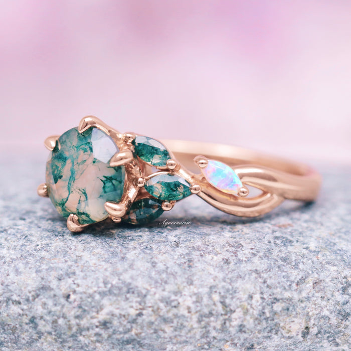 Enchanted Garden Green Moss Agate & Fire Opal Ring- 14K Solid Rose Gold featuring a unique green moss agate center with pear-shaped green sapphires and iridescent fire opal accents, crafted by Aquamarise Gold from nature-inspired collections.