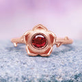 Enchanted Rose Red Garnet Ring- 14K Rose Gold Vermeil by Aquamarise, featuring a round red garnet set within a delicate rose-shaped bezel on a smooth rose gold vermeil band, part of Rose Gold Vermeil Rings and January Birthstone Jewelry collections.