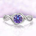 Entwined Alexandrite Ring in Sterling Silver by Aquamarise, featuring a round color-change stone with a twisting band accented by sparkling pavé crystals in a modern, elegant design.