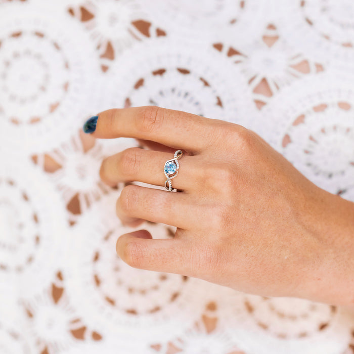Entwined Aquamarine Ring- Sterling Silver by Aquamarise, featuring a blue aquamarine stone with an elegant twisted band, perfect for promise and engagement rings in sterling silver.