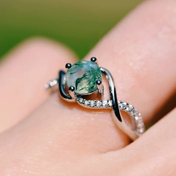 Entwined Green Moss Agate Ring- Sterling Silver by Aquamarise, featuring a natural moss agate cabochon with a twisted sterling silver band accented with small pavé stones.