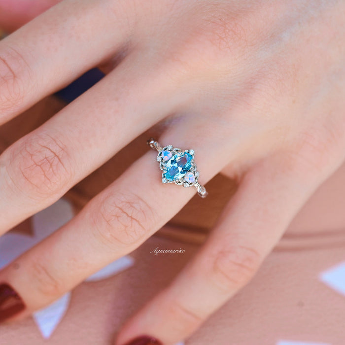 Esme Aquamarine & Opalescent Sapphire Ring in 14K White Gold featuring a light blue aquamarine center flanked by opalescent sapphires on a delicate white gold band by Aquamarise Gold.