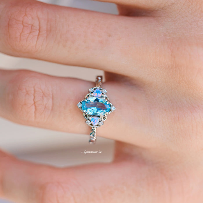 Esme Aquamarine & Opalescent Sapphire Ring in 14K White Gold featuring an elongated aquamarine center with shimmering sapphires on an elegant band by Aquamarise Gold.