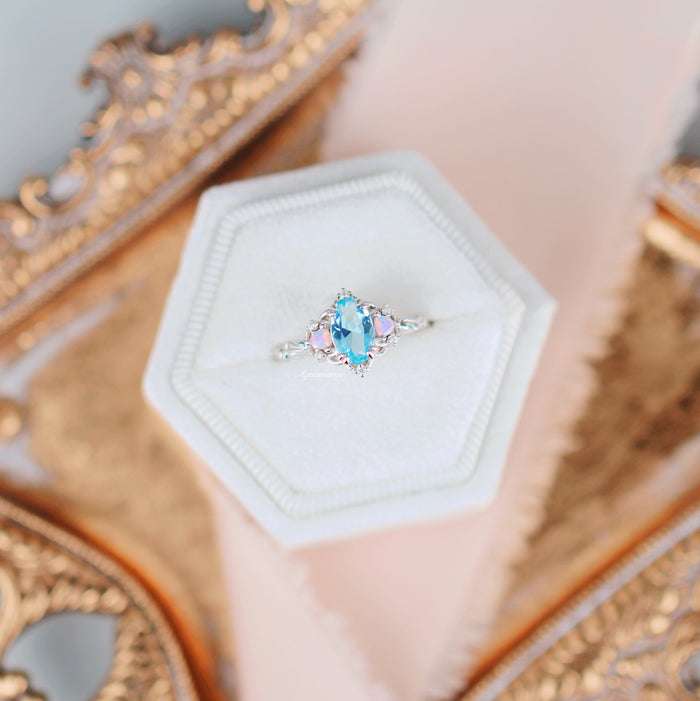 Esme Aquamarine & Opalescent Sapphire Ring in 14K White Gold featuring an oval aquamarine center with delicate opalescent sapphires on an elegant white gold band by Aquamarise Gold.