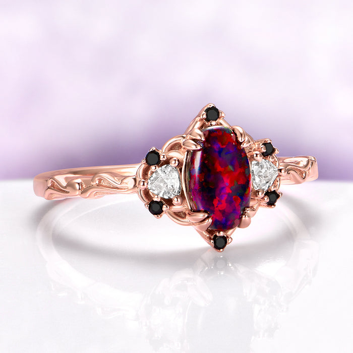 Esme Black Fire Opal & Onyx Ring in 14K Rose Gold Vermeil by Aquamarise, featuring a vibrant black fire opal center with onyx and white gemstone accents in a rose gold setting.