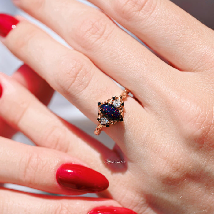 Esme Black Fire Opal Ring- 14K Rose Gold Vermeil by Aquamarise featuring a marquise black fire opal with sparkling accents on a delicate rose gold band.