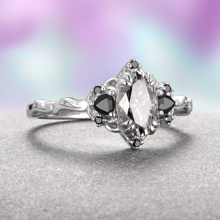 Esme Gray Moissanite & Black Onyx Ring in Sterling Silver by Aquamarise features a marquise gray moissanite center flanked by black onyx accents on a sculpted sterling silver band from the Lovers of the Dark™ and Nature-Inspired Engagement Rings collections.