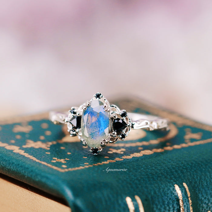 Esme Labradorite & Black Onyx Engagement Ring in 14K White Gold featuring a luminous labradorite center stone with intricate black onyx accents on a finely detailed band, crafted by Aquamarise Gold from non-traditional and nature-inspired solid gold engagement ring collections.