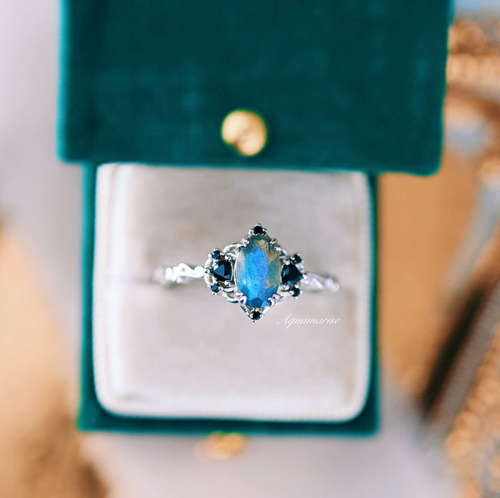 Esme Labradorite & Black Onyx Engagement Ring in 14K White Gold featuring a marquise labradorite centerpiece surrounded by black onyx accents on a detailed band, presented in a velvet ring box by Aquamarise Gold from nature-inspired and non-traditional engagement collections.