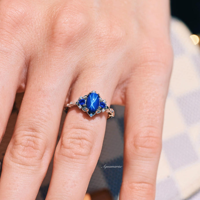 Esme Natural Star Sapphire Engagement Ring in Sterling Silver on hand, featuring a luminous star sapphire with blue gemstone accents by Aquamarise from Sterling Silver Rings and September Birthstone Jewelry collections.