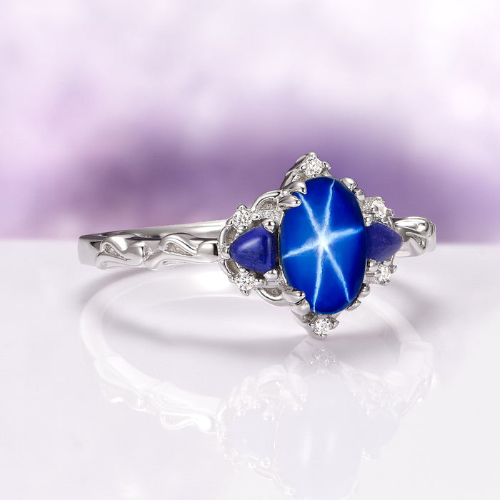 Esme Natural Star Sapphire Engagement Ring in Sterling Silver by Aquamarise featuring a vibrant star sapphire with two blue side stones and detailed silverwork from Sterling Silver Rings and September Birthstone Jewelry.