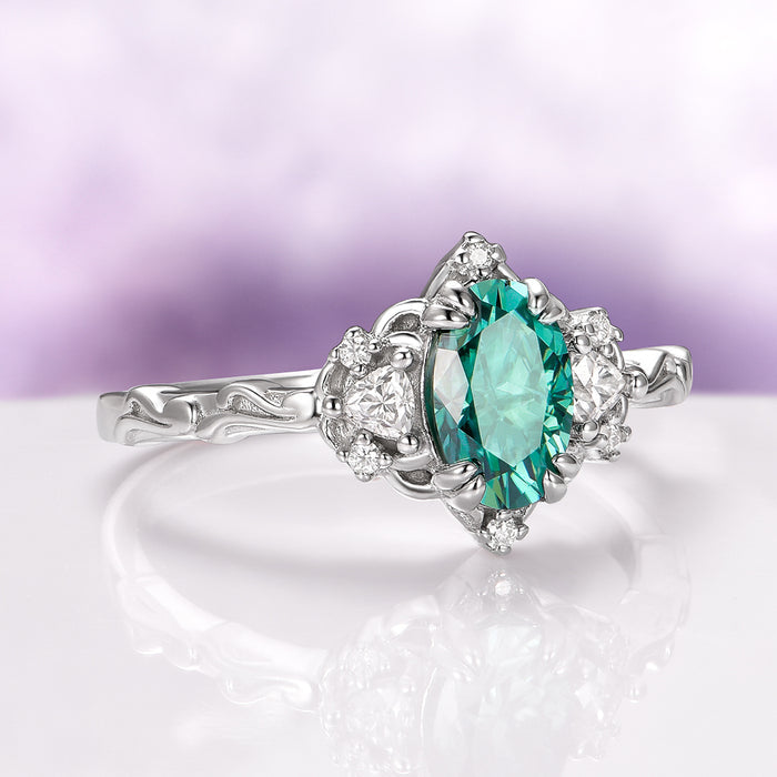 Esme Oval Cut Teal Moissanite Engagement Ring in 14K White Gold by Aquamarise Gold with intricate band and sparkling side moissanite stones, a unique non-traditional engagement ring.