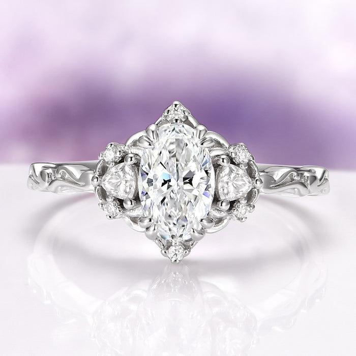 Diamond ring with a oval-shaped center stone on a soft purple background