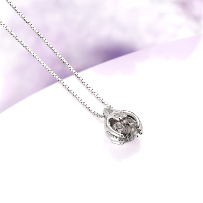 Ethereal Hold Natural Herkimer Diamond Pendant Necklace in Sterling Silver by Aquamarise, featuring sculpted silver hands gently embracing a raw natural Herkimer diamond on a delicate sterling silver chain, part of Necklaces and Birthstone Jewelry collections.