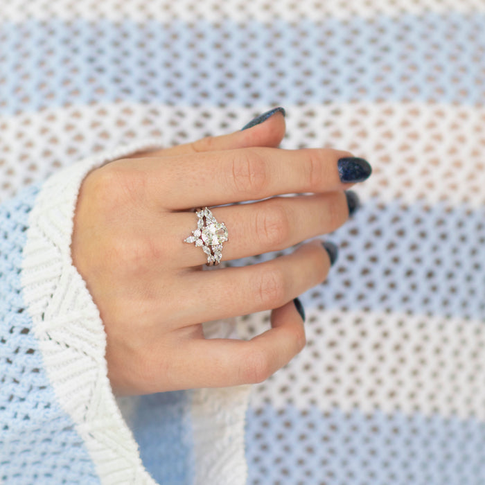 Evelyn Oval Cut White Sapphire Engagement Ring in Sterling Silver by Aquamarise, shown on hand with soft knit white sweater background, part of Sterling Silver Rings, September Birthstone Jewelry, and Engagement Rings for Women collections.