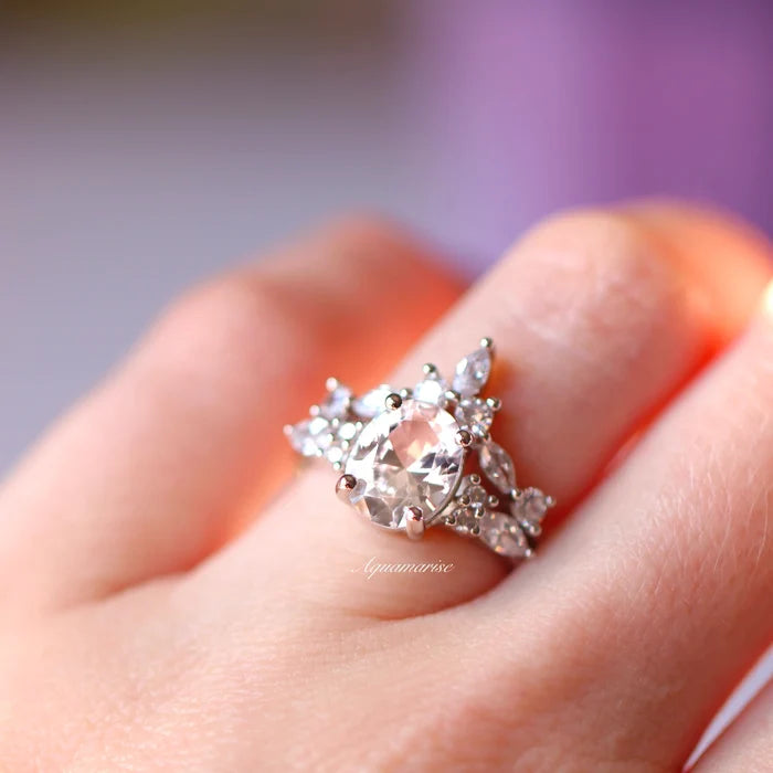 Evelyn Oval Cut White Sapphire Engagement Ring in Sterling Silver by Aquamarise, showcasing a sparkling oval-cut lab-grown white sapphire center surrounded by delicate accent stones, part of Sterling Silver Rings and Engagement Rings for Women collections.