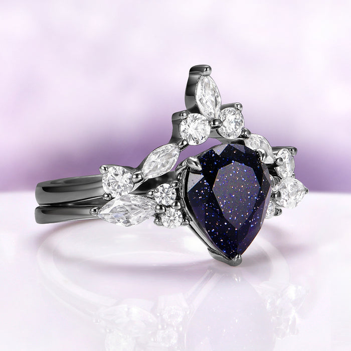 Evelyn Starry Night Ring Set in Black Ruthenium by Aquamarise, featuring a pear-shaped blue sandstone with sparkling accents on black ruthenium sterling silver bands.