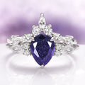 Evelyn Starry Night Engagement Ring Set in 14K White Gold by Aquamarise Gold, featuring a pear-shaped deep blue gemstone and sparkling white diamond accents in a celestial-inspired design.
