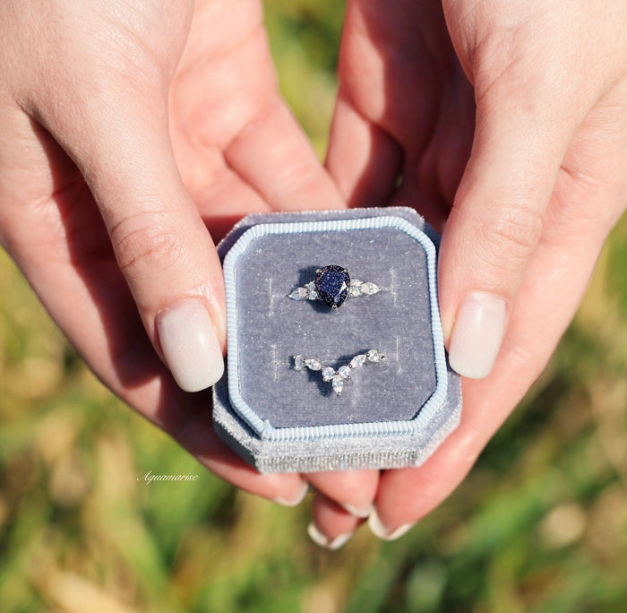 Evelyn Starry Night Engagement Ring Set in 14K White Gold by Aquamarise Gold, featuring a pear-shaped deep blue gemstone with diamond accents in a celestial-inspired design.
