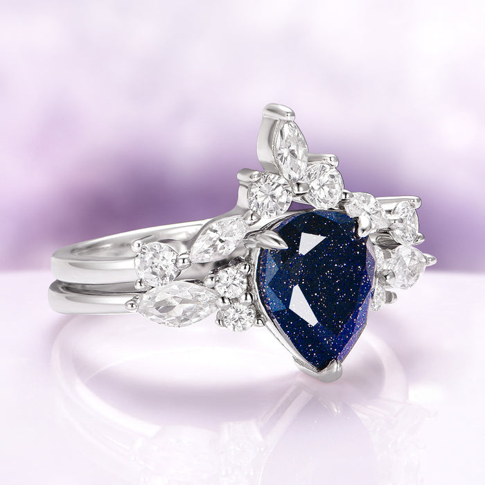 Evelyn Starry Night Engagement Ring Set in 14K White Gold with a pear-shaped deep blue gemstone and marquise and round diamonds by Aquamarise Gold, inspired by the cosmos.
