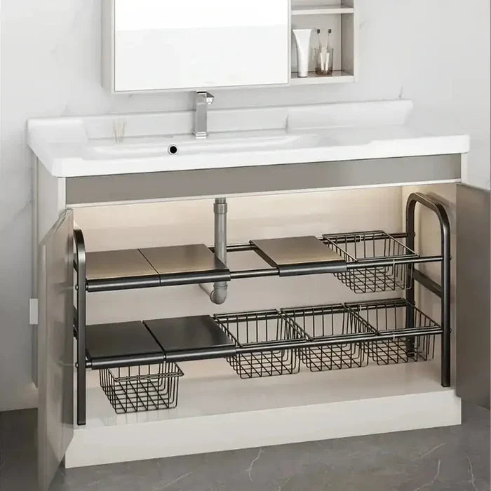 Expandable under sink shelf organizer with adjustable shelves and wire baskets for efficient cabinet storage.