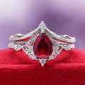 Fireworks Cut Lab-Grown Ruby Engagement Ring Set in Sterling Silver by Aquamarise, styled on red velvet to highlight the ruby centre.