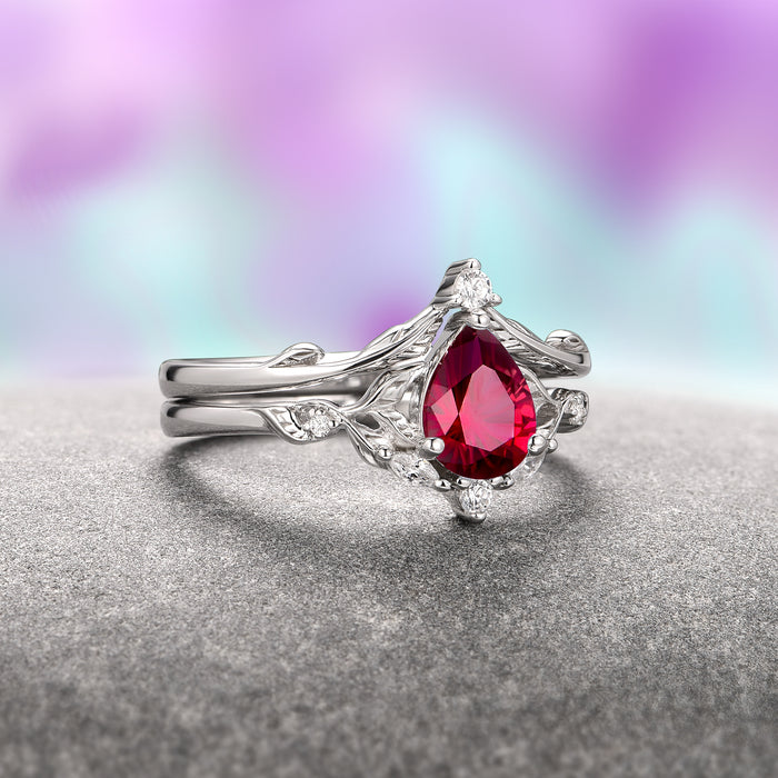 Fireworks Cut Lab-Grown Ruby Engagement Ring Set in 14K White Gold (Two Piece) by Aquamarise Gold, featuring a teardrop-shaped ruby centerpiece with delicate leaf-inspired white gold bands, from the Solid Gold Engagement Rings and July Birthstone Jewelry collections.