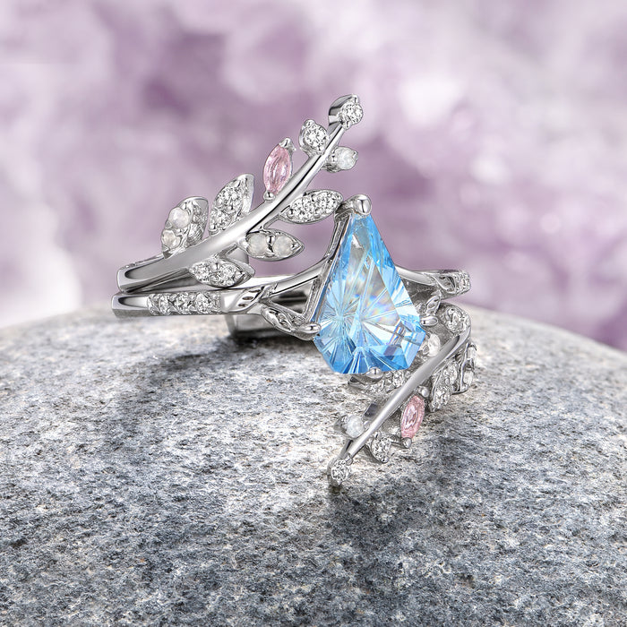 Fantasy Shield Cut Aquamarine & Rose Quartz Leaf Ring Set- 14K White Gold (Two Piece) by Aquamarise Gold, featuring a pear-shaped aquamarine centerpiece with delicate rose quartz accents and intricate leaf-inspired 14K white gold bands, ideal for nature-inspired and non-traditional engagement rings.