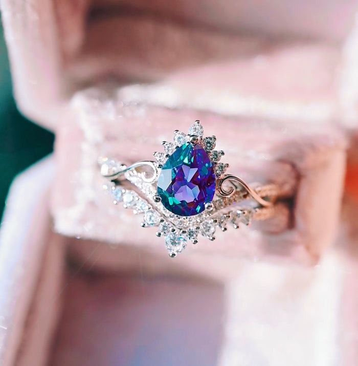 Faye Alexandrite Ring Set- 14K White Gold (Two Piece) featuring a pear-shaped alexandrite center stone surrounded by delicate diamond accents on a white gold band, from Aquamarise Gold’s nature-inspired and fantasy engagement collections.