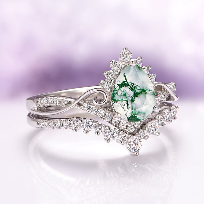Faye Green Moss Agate Engagement Ring Set in Sterling Silver by Aquamarise, featuring a pear-shaped moss agate with green inclusions and intricate diamond accents in a nature-inspired design.
