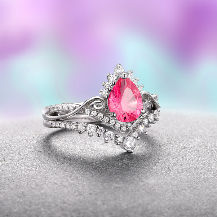 Faye Pink Sapphire Engagement Ring Set- 14K White Gold (Fantasy Cut) by Aquamarise Gold, showcasing a pear-shaped vivid pink sapphire surrounded by intricate white diamond accents on a delicately twisted white gold band, part of the September Birthstone Jewelry and Fantasy-Inspired Engagement Rings collections.