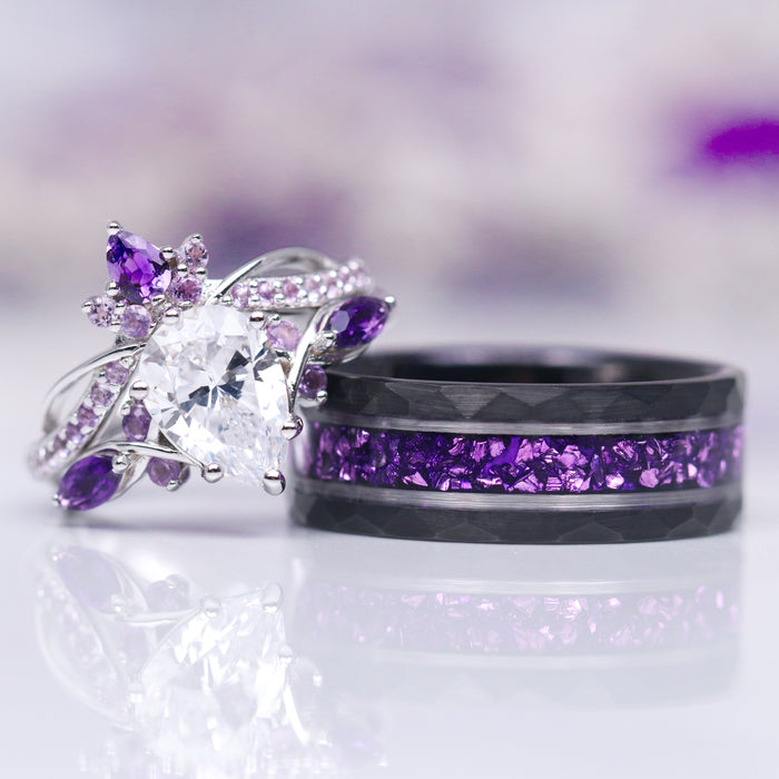 Feyra Amethyst & Simulated Diamond Couples Ring Set featuring a delicate silver ring with a pear-shaped simulated diamond and amethyst accents, paired with a black band inlaid with vibrant crushed amethyst stones, designed by Aquamarise.