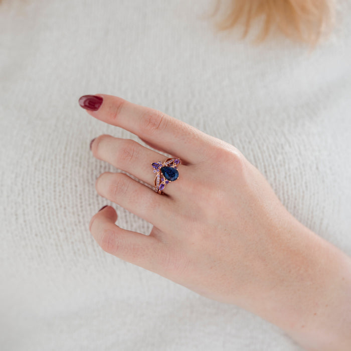 Feyra Starry Night & Amethyst Couples Ring Set by Aquamarise featuring a pear-shaped blue sandstone centerpiece paired with purple amethyst accents on an elegant rose gold band, part of Matching Couples' Rings and Starry Night™ Rings collections.
