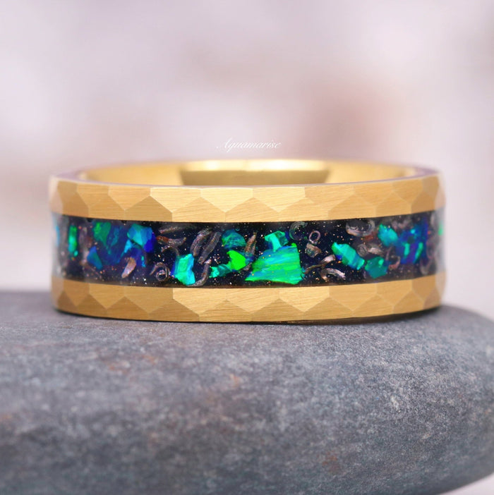 Fire Opal, Meteorite & Starry Night Wedding Band- 8MM Gold Tungsten featuring an 8MM hammered gold tungsten carbide band with an inlay of vibrant galaxy green fire opal mixed with meteorite fragments, from Aquamarise’s Starry Night™ Rings and Men's Wedding Bands collections.