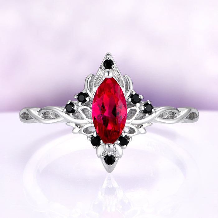 Fire Queen Marquise Ruby & Black Onyx Engagement Ring in 14K White Gold by Aquamarise Gold, featuring a marquise ruby center with black onyx accents on an intricate white gold band.
