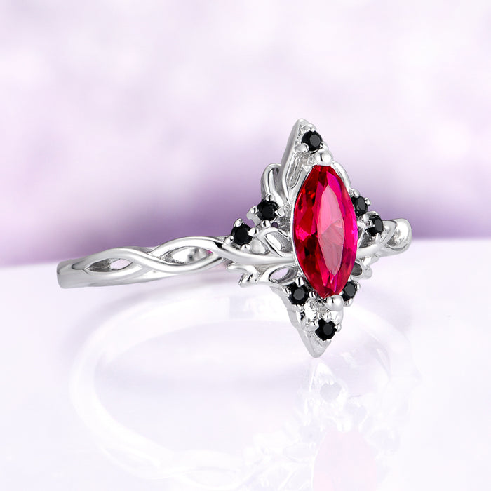 Fire Queen Marquise Ruby & Black Onyx Engagement Ring in 14K White Gold by Aquamarise Gold, featuring a marquise ruby center with black onyx accents on an intricate white gold band.