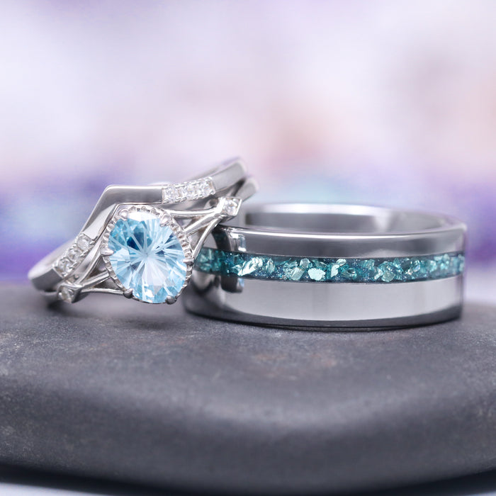 Fireworks Cut Aquamarine Couples Ring Set by Aquamarise, featuring a radiant aquamarine center stone with delicate silver filigree and diamond accents paired with a sleek band inlaid with crushed aquamarine, part of Matching Couples' Rings and March Birthstone Jewelry collections.