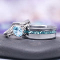 Fireworks Cut Aquamarine Couples Ring Set by Aquamarise, featuring a radiant aquamarine center stone with delicate silver filigree and diamond accents paired with a sleek band inlaid with crushed aquamarine, part of Matching Couples' Rings and March Birthstone Jewelry collections.