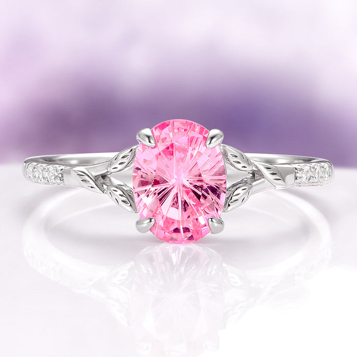 Fireworks Cut Pink Sapphire Leaf Engagement Ring in 14K White Gold by Aquamarise Gold featuring an oval lab-grown pink sapphire with delicate leaf-inspired white gold details and diamond accents, part of Solid Gold Engagement Rings and Nature-Inspired Engagement Rings collections.
