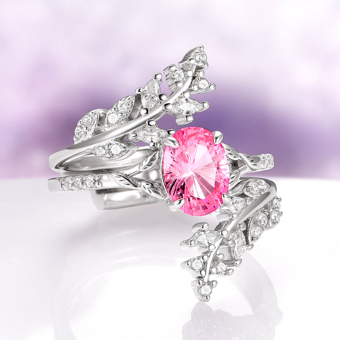 Fireworks Cut Pink Sapphire Leaf Engagement Ring in 14K White Gold by Aquamarise Gold featuring an oval fireworks-cut pink sapphire center with intricate leaf-inspired white gold details and diamond accents, part of Solid Gold Engagement Rings and Nature-Inspired Engagement Rings collections.