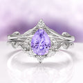 Fireworks Cut Lab-Grown Lavender Sapphire Engagement Ring Set in 14K White Gold by Aquamarise Gold, featuring a pear-shaped lavender sapphire centerpiece with intricate white gold vine-inspired detailing and delicate diamond accents, from the Solid Gold Engagement Rings and Nature-Inspired Engagement Rings collections.