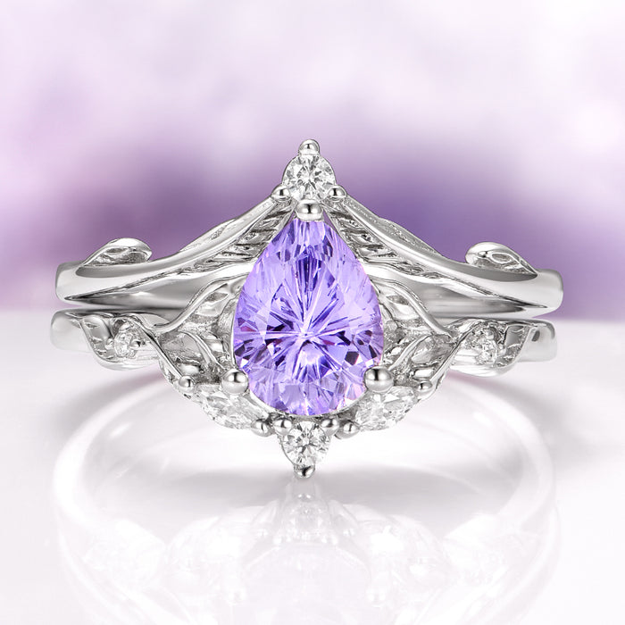Fireworks Cut Lab-Grown Lavender Sapphire Engagement Ring Set in 14K White Gold by Aquamarise Gold, featuring a pear-shaped lavender sapphire centerpiece with intricate white gold vine-inspired detailing and delicate diamond accents, from the Solid Gold Engagement Rings and Nature-Inspired Engagement Rings collections.