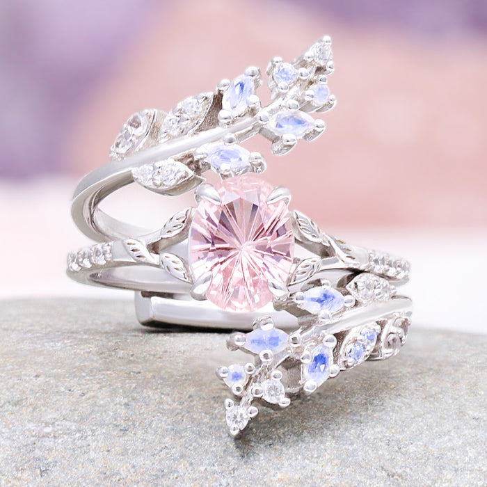 Fireworks Cut Morganite & Moonstone Leaf Couples Ring Set featuring a pink morganite center with moonstone and sparkling accents on leaf-inspired sterling silver bands by Aquamarise.