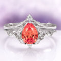 Fireworks Cut Padparadscha Sapphire Engagement Ring Set in 14K White Gold by Aquamarise Gold featuring a pear-shaped fiery padparadscha sapphire centerpiece with detailed leaf-inspired white gold band and diamond accents, part of Solid Gold Engagement Rings and September Birthstone Jewelry collections.