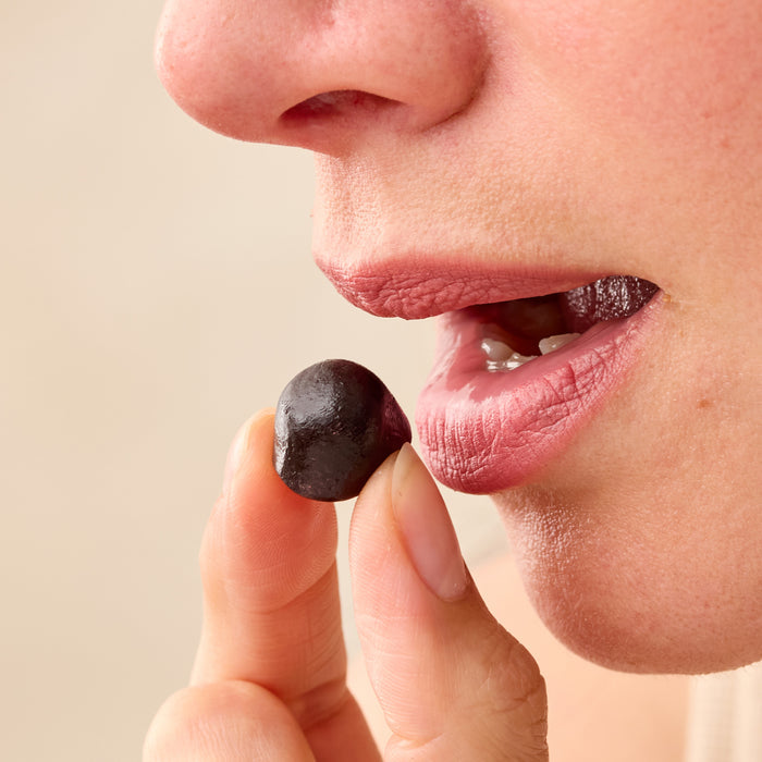 Close-up of a person holding and about to eat a Juice Plus+ chewable