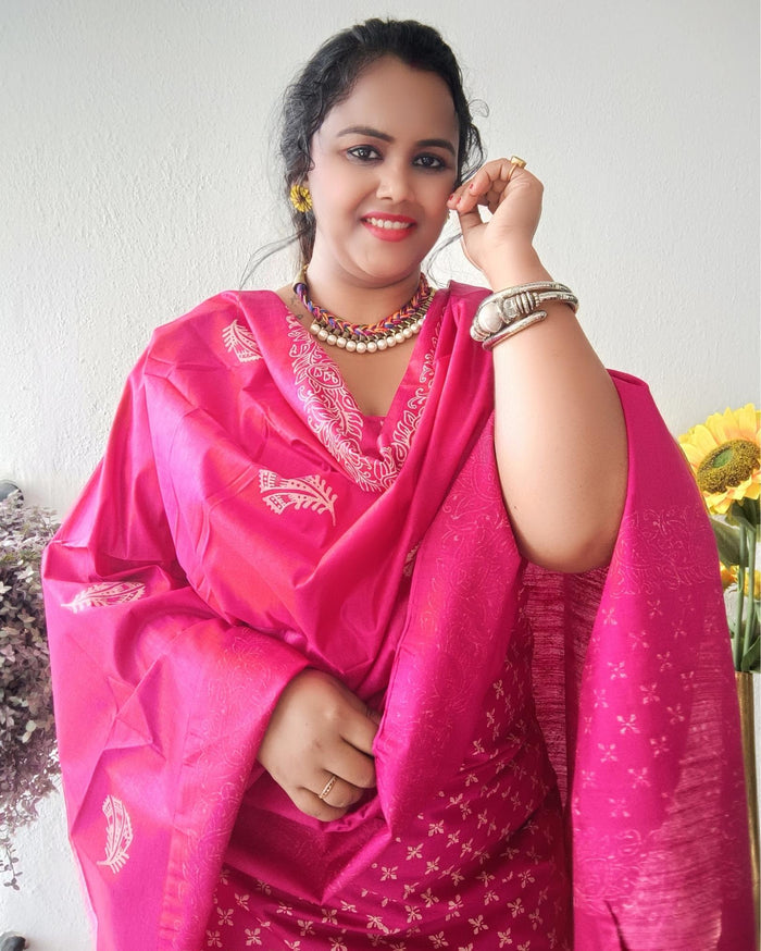 Vivid fuchsia pink katan silk unstitched suit set with a large hand block printed feather-like botanical motif on the dupatta