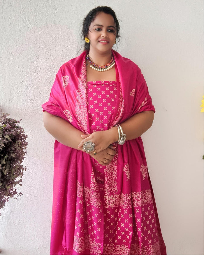 Vivid fuchsia pink katan silk unstitched suit set with a large hand block printed feather-like botanical motif on the dupatta