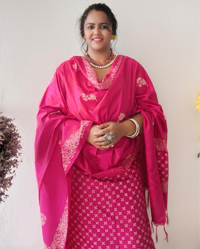 Vivid fuchsia pink katan silk unstitched suit set with a large hand block printed feather-like botanical motif on the dupatta