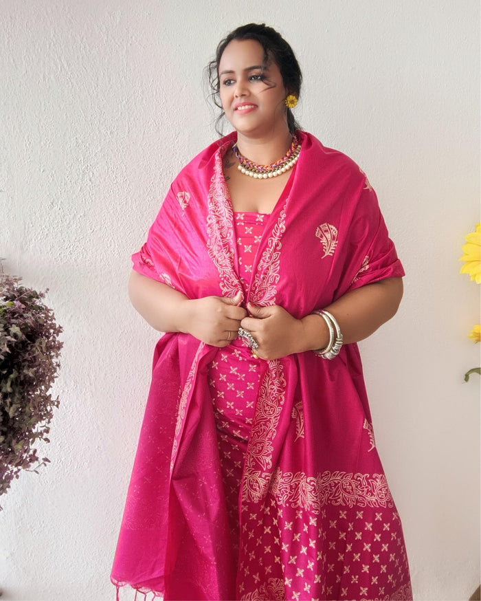 Vivid fuchsia pink katan silk unstitched suit set with a large hand block printed feather-like botanical motif on the dupatta